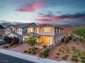 Charming two-story home showcasing desert landscaping, a brick driveway, and a cozy front porch at 2832 Aragon Terrace Way, Henderson, NV 89044