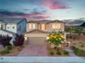 Beautiful two-story home with well-maintained landscaping, a brick driveway, and a two-car garage at 2832 Aragon Terrace Way, Henderson, NV 89044