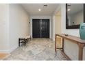 Elegant entryway featuring double doors, light walls, and beautiful marble flooring, creating a welcoming space at 3007 La Mesa Dr, Henderson, NV 89014
