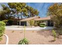 Inviting single-story home with a circular driveway and desert landscaping for a low-maintenance yard at 3007 La Mesa Dr, Henderson, NV 89014