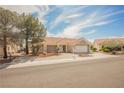 Street view of a quaint single-story home featuring a well-kept front yard and attached two-car garage at 3116 Richland Dr, Las Vegas, NV 89134