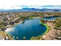 Breathtaking aerial view of community lake, showcasing the waterfront homes and mountain backdrop at 3151 Soaring Gulls Dr # 1201, Las Vegas, NV 89128