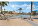 Community pool and recreation area, surrounded by lush landscaping and palm trees by the lagoon at 3151 Soaring Gulls Dr # 1201, Las Vegas, NV 89128