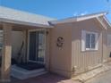 Exterior side view of the residence showcasing the entrance, siding, and landscaping at 3451 Ramona Ln, Pahrump, NV 89048