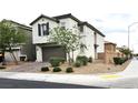 Charming two-story home features a brown garage door and desert landscaping at 4109 Cloudless Ave, North Las Vegas, NV 89081