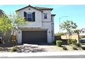 Charming two-story home features a brown garage door and desert landscaping at 4109 Cloudless Ave, North Las Vegas, NV 89081