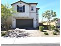 Charming two-story home features a brown garage door and desert landscaping at 4109 Cloudless Ave, North Las Vegas, NV 89081