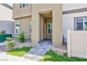 Covered entrance of a two-story townhome with desert landscaping at 4145 Lunar Canyon Ave, North Las Vegas, NV 89084