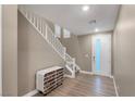 Bright entryway with modern decor, white stairs, and wood-look flooring at 4193 Solace St # 4193, Las Vegas, NV 89135