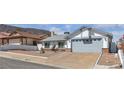 Single story home featuring an attached garage and desert landscaping at 468 Potomac St, Henderson, NV 89015