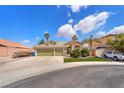 Inviting single-story home showcases a well-maintained lawn, long driveway, and a convenient three-car garage at 4878 Friar Tuck Ave, Las Vegas, NV 89130