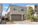 Attractive two-story home with brick-paved driveway, two car garage, elegant architectural details, and lush landscaping at 5419 Holding Ave, Las Vegas, NV 89139