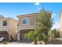 Inviting two-story home with a covered two car garage, brick driveway, arched windows, and mature trees in the front at 5419 Holding Ave, Las Vegas, NV 89139