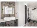 Modern bathroom featuring a stylish vanity, vessel sink, and sleek, tiled shower with black trim at 5612 Coder Ct, Las Vegas, NV 89118
