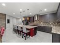 Spacious kitchen with large island, bar seating, stainless steel appliances, and pendant lighting at 6331 Regina Ridge St, Las Vegas, NV 89149