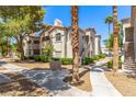 Exterior condo view features a walkway and cozy outdoor grill surrounded by lush trees at 6480 Annie Oakley Dr # 814, Las Vegas, NV 89120