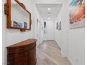 Bright hallway features beautiful wood floors, elegant decor, and a welcoming atmosphere at 7058 W Camero Ave, Las Vegas, NV 89113