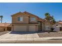 Two-story home featuring a three-car garage, desert landscaping, and neutral color palette at 723 Seclusion Glen Ave, Las Vegas, NV 89123