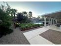 Lush backyard garden with blooming flowers and gravel pathway offers a serene outdoor space at 7451 Mystic Stream St, Las Vegas, NV 89131