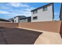 Spacious, blank canvas backyard offers a walled boundary, ready for your custom landscaping dreams and outdoor living designs at 7482 Lodano Ave, Las Vegas, NV 89113