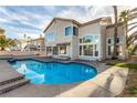 Beautiful pool with tiled trim and a spacious patio, perfect for entertaining or enjoying the outdoors at 7900 Riviera Beach Dr, Las Vegas, NV 89128