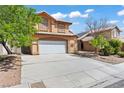Charming two-story home featuring a desert landscape and a two-car garage, ideal for curb appeal at 7954 Kentshire Dr, Las Vegas, NV 89117