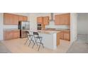 Bright kitchen features granite counters, stainless steel appliances, and an island with breakfast bar at 80 Brixton Ave, Henderson, NV 89011
