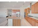 Modern kitchen featuring stainless steel appliances, granite counters, and a kitchen island at 80 Brixton Ave, Henderson, NV 89011