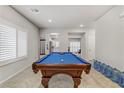 Spacious game room featuring a high-end pool table, neutral paint and plantation shutters at 8351 Gold River Ct, Las Vegas, NV 89113