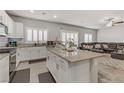 Bright kitchen featuring an island, granite countertops, and stainless appliances at 8351 Gold River Ct, Las Vegas, NV 89113