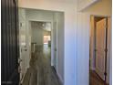 Inviting entryway featuring wood-look flooring and neutral paint, leading to the open living area at 9463 Jumping Frog Ct, Las Vegas, NV 89147
