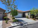 Beautiful single-story home with desert landscaping, a tile roof, and a spacious two-car garage at 9463 Jumping Frog Ct, Las Vegas, NV 89147