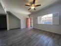 Sun-filled living room featuring wood-look tile flooring, modern ceiling fan and neutral paint at 7701 W Robindale Rd # 127, Las Vegas, NV 89113