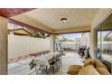 Inviting covered patio with lounge seating, a dining table, and outdoor fitness equipment at 9772 Splendor Sky Ave, Las Vegas, NV 89148