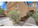 Tan colored two-story home with desert landscaping and neighborhood sidewalks at 11120 Whooping Crane Ln, Las Vegas, NV 89144