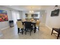 Dining room featuring tile floors, modern furniture, and view into the kitchen at 1740 Capistrano Ave, Las Vegas, NV 89169