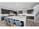 Spacious kitchen with large island, stainless steel appliances, and sleek dark cabinetry at 298 Watteau Ct, Henderson, NV 89012