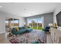 Bright living room with large windows, stylish furnishings, and access to the outdoor living space at 298 Watteau Ct, Henderson, NV 89012