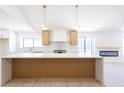 Bright kitchen featuring a stylish island with quartz countertop and decorative wood paneling at 3156 Shadowridge Ave, Las Vegas, NV 89120