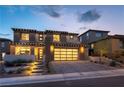 Beautiful two-story home featuring a modern garage door and desert landscaping at 395 Prairie Sun St, Las Vegas, NV 89138