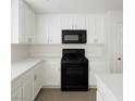 Well-lit kitchen with white cabinets, countertops, and black oven, offering a modern design at 520 Shire Hall St, Las Vegas, NV 89178