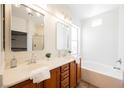 Bright bathroom with double sinks, bathtub and walk-in shower for a spa-like experience at 909 Trinity Pond Cir, Henderson, NV 89002