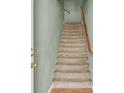 Carpeted staircase featuring a wood handrail, offering access to the upper levels of the home at 10001 Peace Way # 2277, Las Vegas, NV 89147
