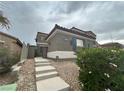 Beautiful home featuring desert landscaping, stone accents, and an ADT security system sign at 10013 Scenic Walk Ave, Las Vegas, NV 89149