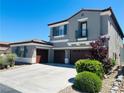 Stylish two-story home with a three-car garage, charming shutters and desert landscaping at 10013 Scenic Walk Ave, Las Vegas, NV 89149