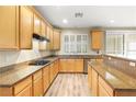 Spacious kitchen boasts wood cabinetry, sleek countertops, stainless steel appliances, and recessed lighting at 10013 Scenic Walk Ave, Las Vegas, NV 89149
