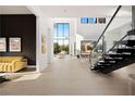 Bright, open living area with soaring ceilings, modern staircase, and stylish furnishings at 10756 Steel Ridge Ct, Las Vegas, NV 89135