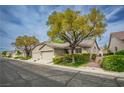 Charming single-story home with two-car garage, lush landscaping, and a well-kept yard in a peaceful neighborhood at 10980 Ampus Pl, Las Vegas, NV 89141