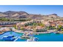 Aerial view of a waterfront community with mountain views, beautiful architecture, and boat docks at 12 Tatahatso Point St, Henderson, NV 89011