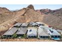Aerial view of desert homes with pools, solar panels, mountain views, and desert landscaping at 12 Tatahatso Point St, Henderson, NV 89011